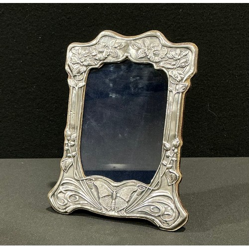 98 - An Elizabeth II Art Nouveau style silver photograph frame, embossed with scrolling blossom and a but... 