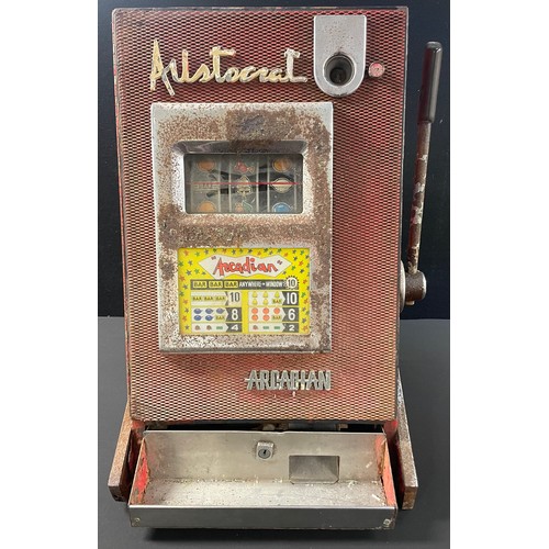 A mid-century cast metal Aristocrat Arcadian slot machine, each wheel ...
