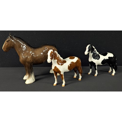 5023 - A Beswick model of a bay Shire Horse, 21.5cm; a Beswick piebald pony and a Beswick chestnut skewbald... 