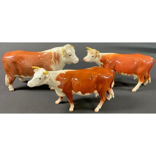 A Beswick cattle group, comprising early Hereford Bull, number 949 and ...