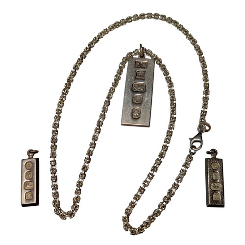 A silver ingot pendant necklace and two smaller ingot pendants, the ...