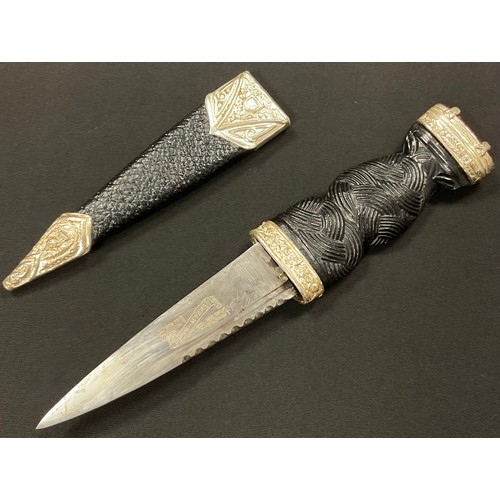 A Scottish sgian dubh dagger, 9.5cm blade with serrated edge, the hilt ...