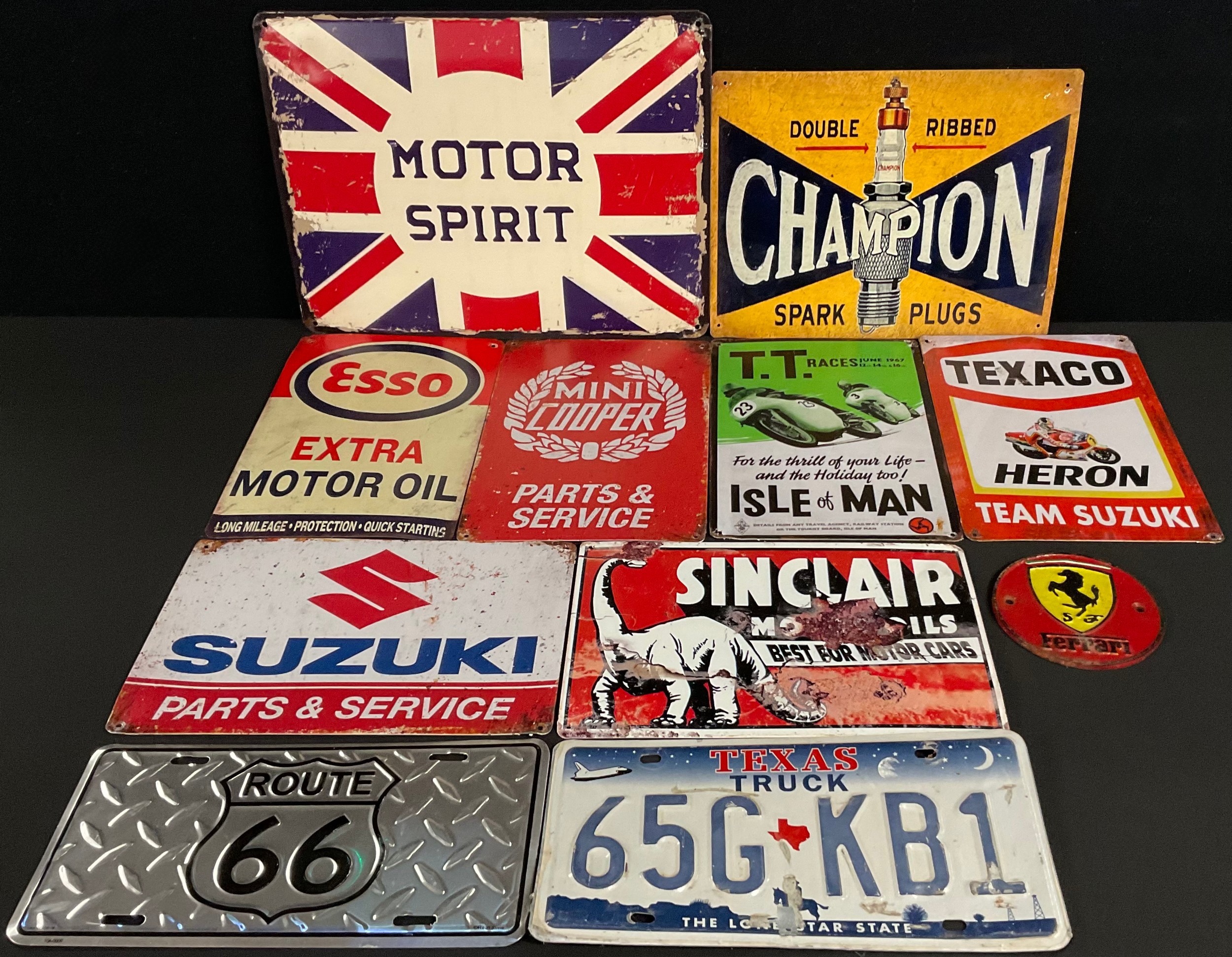 A collection of reproduction advertising signs, including BSA ...