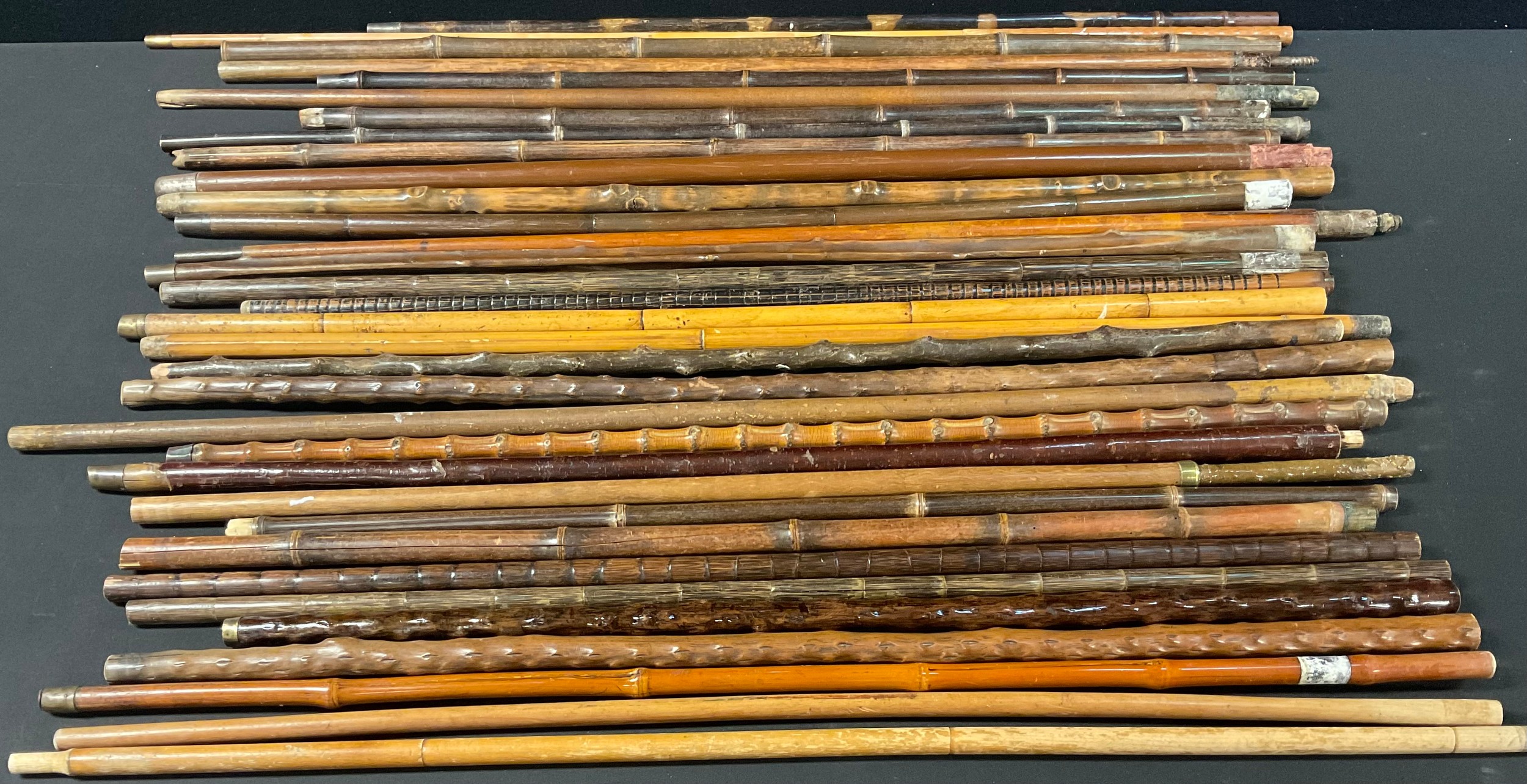 A collection of thirty-three 19th century and later walking stick canes ...