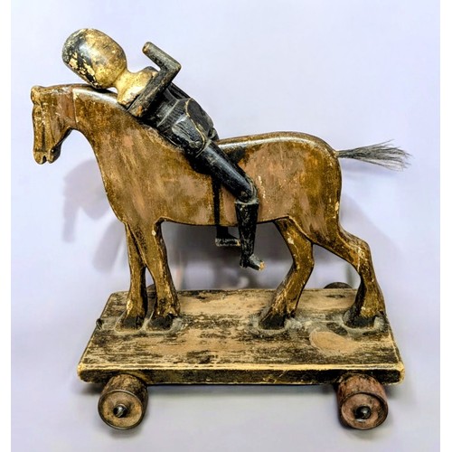 7350 - Juvenalia & Folk Art - a late Victorian pull along horse, horse hair tail, metal wheels, 37cm long, ... 