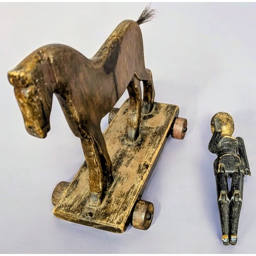 7350 - Juvenalia & Folk Art - a late Victorian pull along horse, horse hair tail, metal wheels, 37cm long, ... 