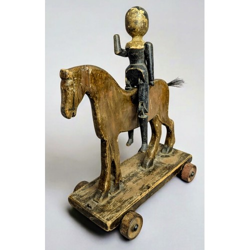 7350 - Juvenalia & Folk Art - a late Victorian pull along horse, horse hair tail, metal wheels, 37cm long, ... 