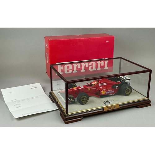 7329 - Formula 1 - a well displayed Paul's Model Art 1/12 scale Ferrari F310 Eddie Irvine F1 racing car, in... 