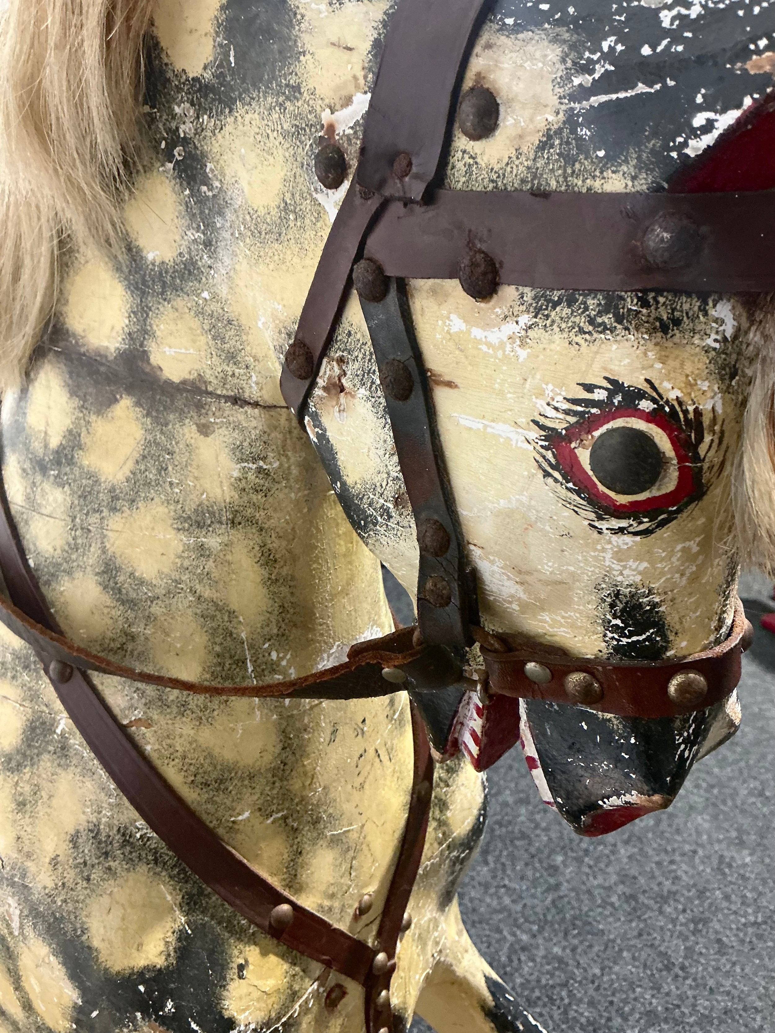 An Edwardian rocking horse, the carved and painted dapple grey body ...