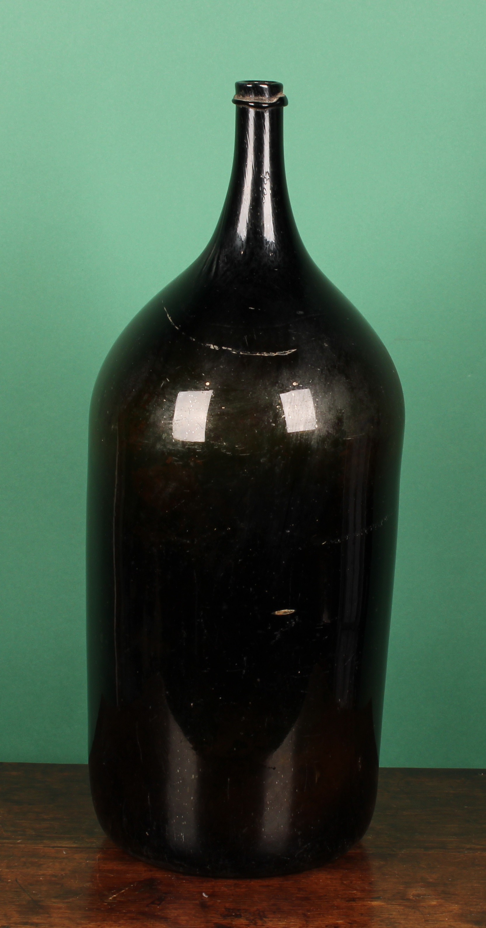 A large French free blown olive/black glass wine bottle or demijohn ...