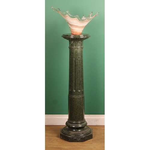 A 19th century serpentine statuary pedestal, circular top, fluted ...