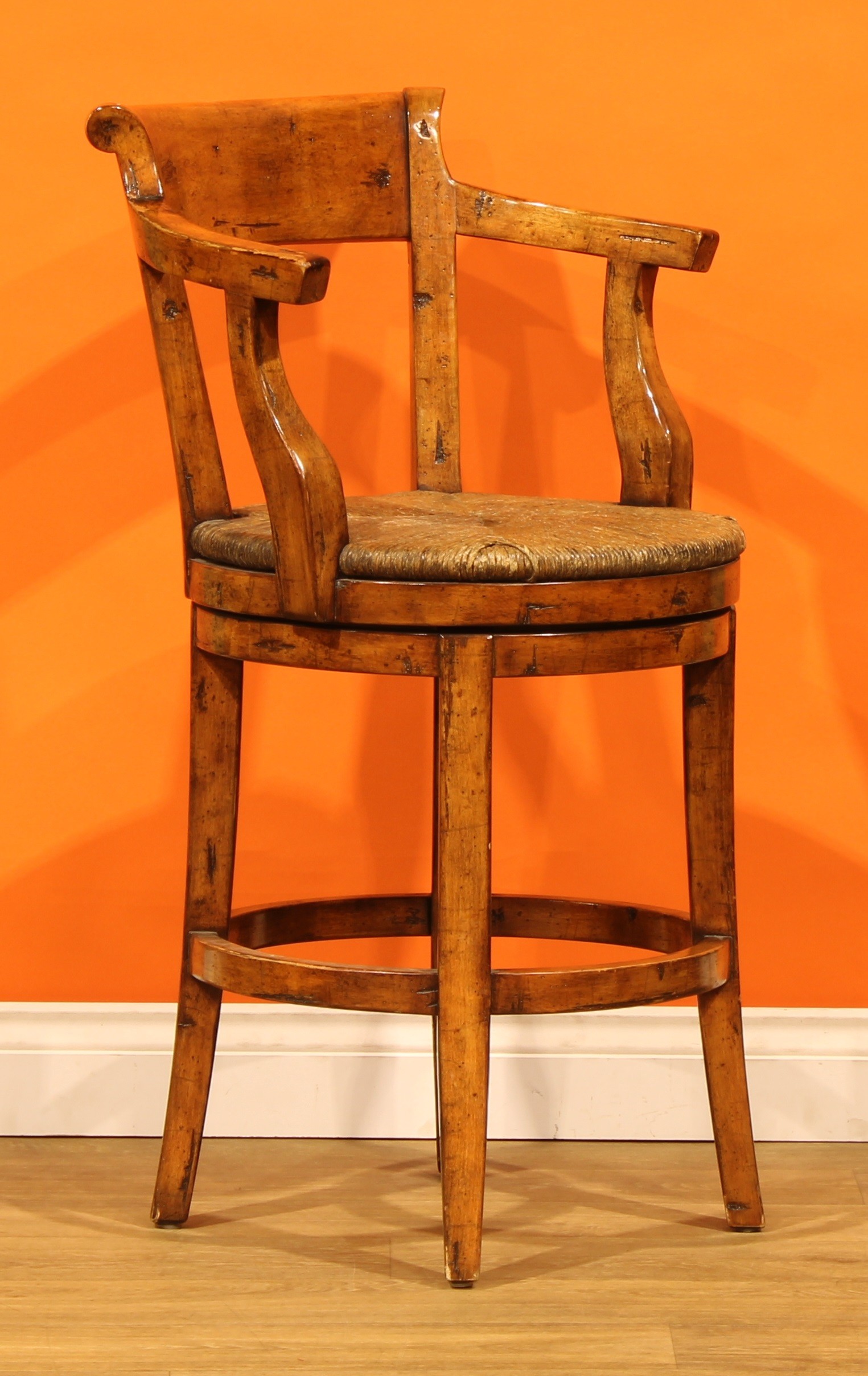 A pair of contemporary fruitwood swivel bar stools, possibly Guy ...