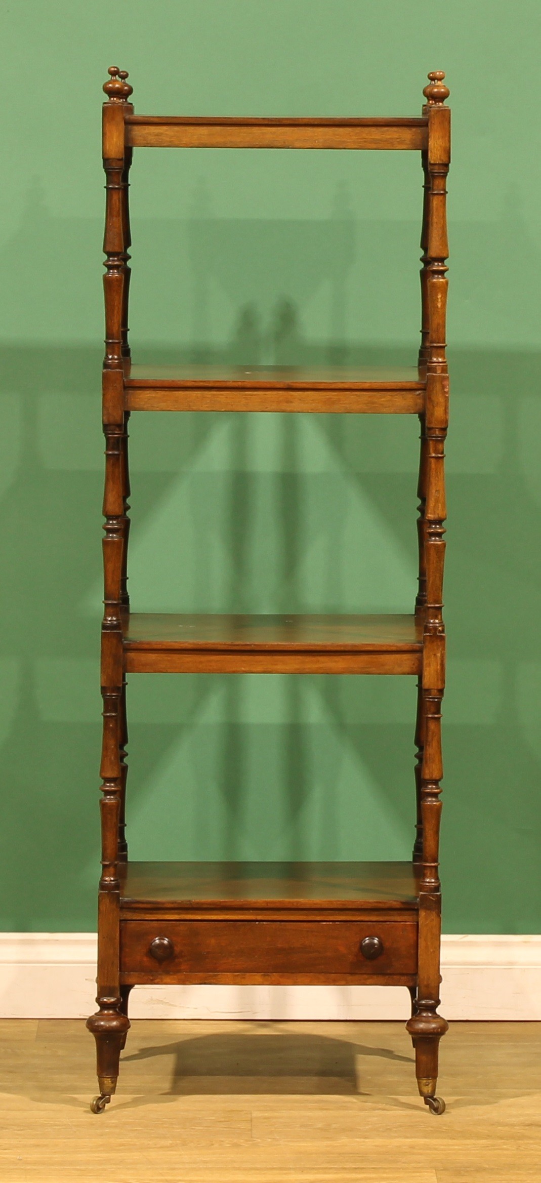 A Victorian mahogany four-tier whatnot, rectangular plateaux, turned ...