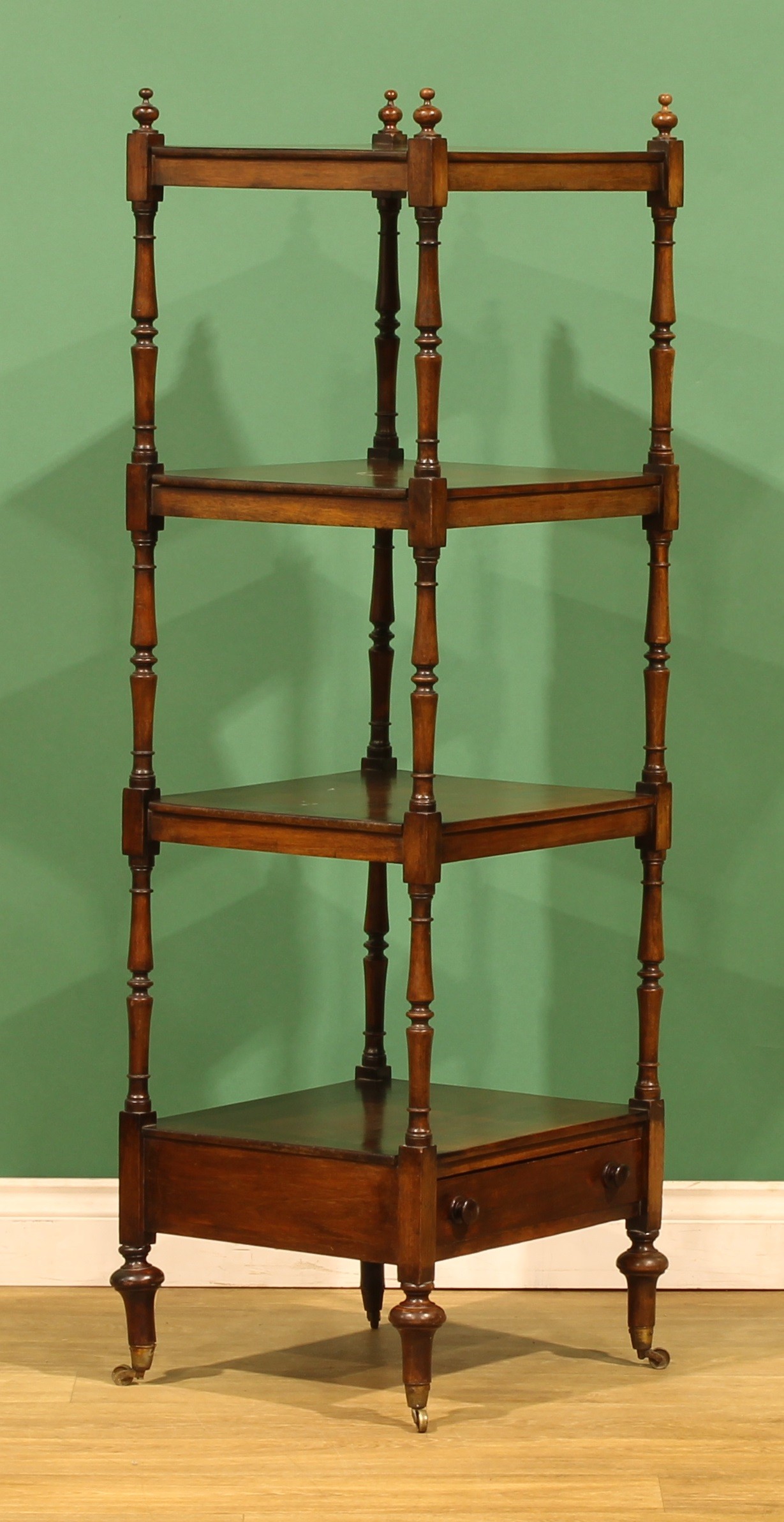A Victorian mahogany four-tier whatnot, rectangular plateaux, turned ...