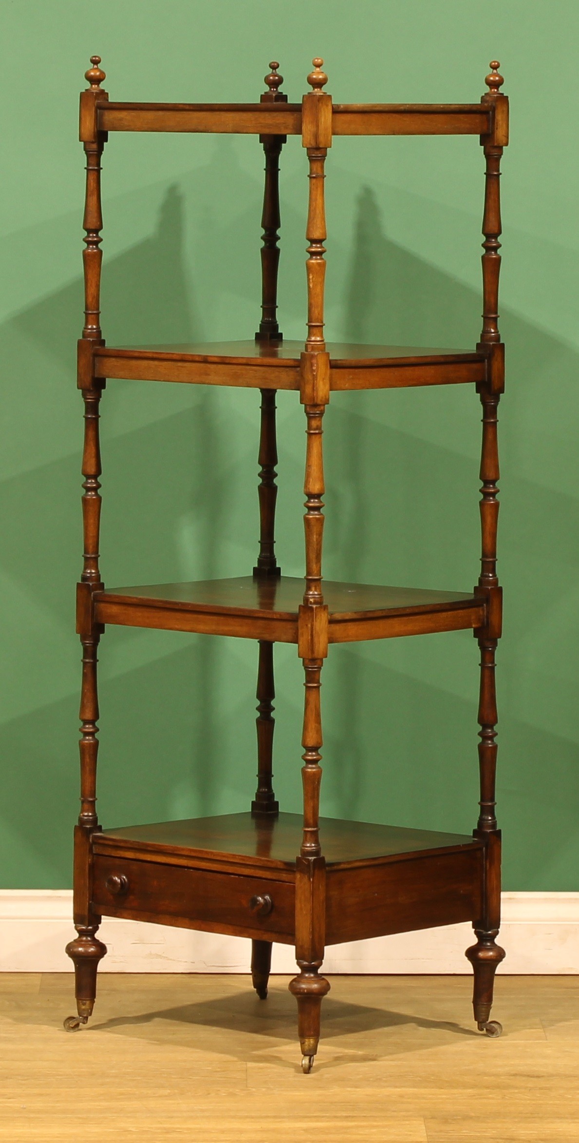 A Victorian mahogany four-tier whatnot, rectangular plateaux, turned ...