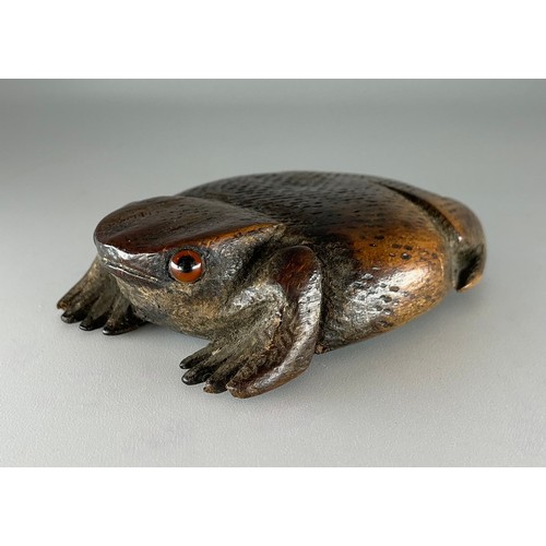 A 19th century fruitwood novelty snuff box, as a toad, glass eyes ...