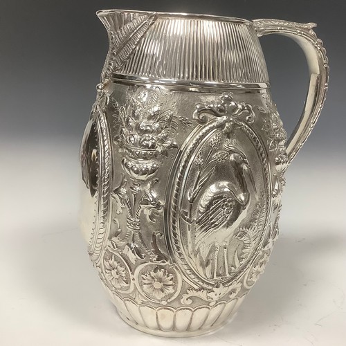 22 - A late Victorian E.P.N.S barrel shaped beer jug, chased with cranes, baskets of fruit, flowers and s... 