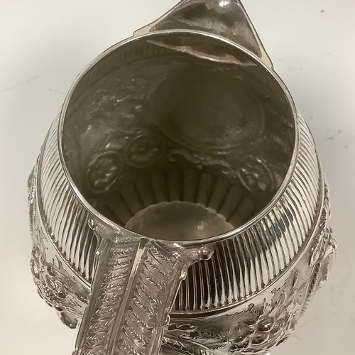 22 - A late Victorian E.P.N.S barrel shaped beer jug, chased with cranes, baskets of fruit, flowers and s... 