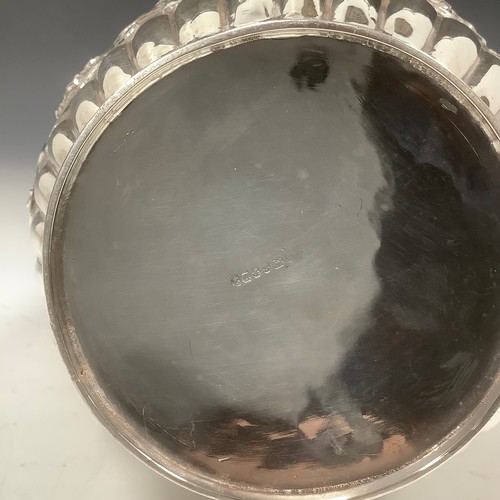 22 - A late Victorian E.P.N.S barrel shaped beer jug, chased with cranes, baskets of fruit, flowers and s... 