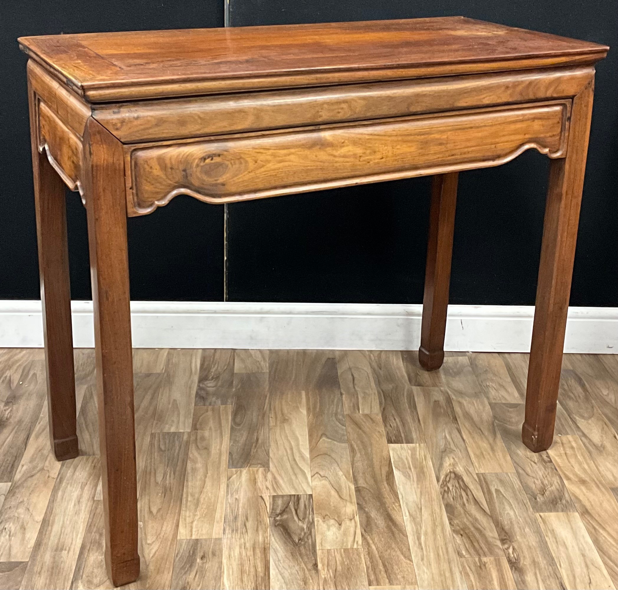 A Chinese hardwood rectangular side table, panelled top above a shaped ...