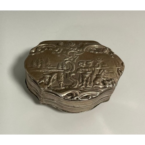 164 - A 19th century Continental silver shell shaped snuff box, hinged cover chased with putti in a landsc... 