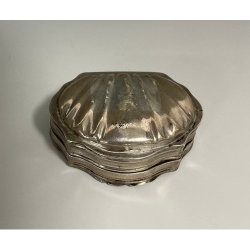 164 - A 19th century Continental silver shell shaped snuff box, hinged cover chased with putti in a landsc... 