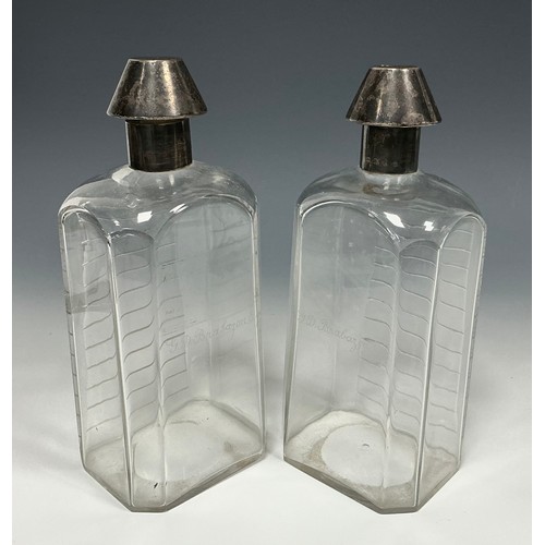 129 - A pair of Victorian silver 'medicine bottle' decanters, cut level indicator notches, conical stopper... 