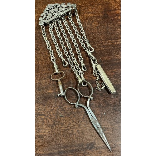 169 - A 19th century silver coloured metal housekeeper's chatelaine, pierced and engraved with flowers and... 