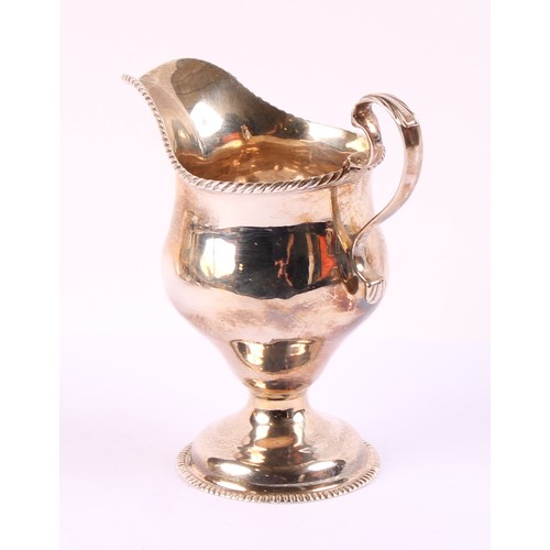 57 - A George II silver ogee shaped pedestal cream jug, gadrooned borders, acanthus capped scroll handle,... 