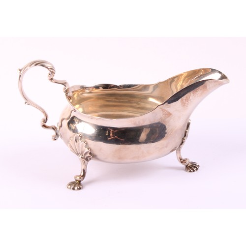 59 - A George II silver sauce boat, wavy rim, acanthus capped double-scroll handle, shell feet, 19cm long... 