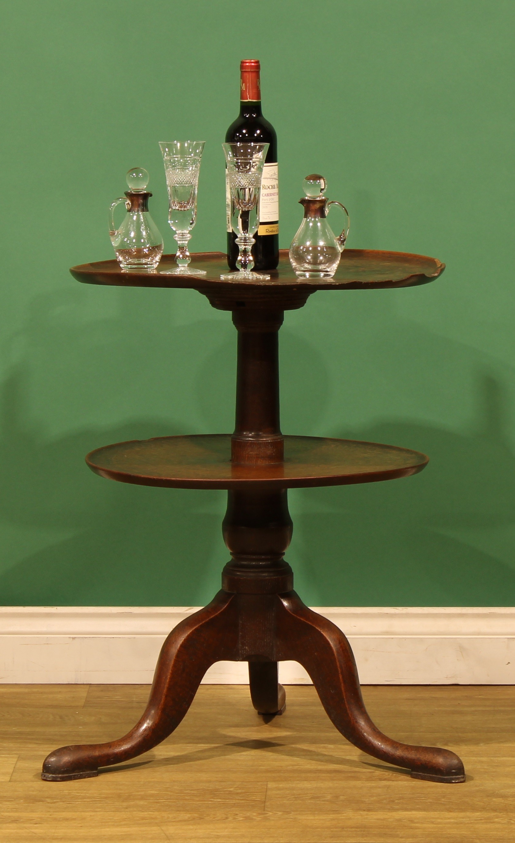 An unusual George III oak two-tier dumbwaiter, turned column, cabriole ...