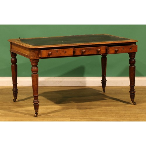 A Victorian mahogany library table, rounded rectangular top above three ...