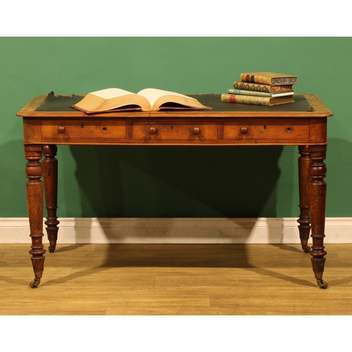 A Victorian mahogany library table, rounded rectangular top above three ...