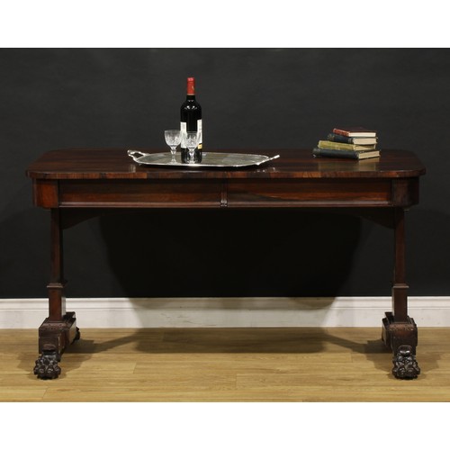 A William IV rosewood library table, rounded rectangular top above a ...