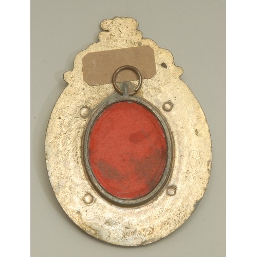 3882 - An Indian enamel plaque, decorated in polychrome with a female deity, the brass frame chased with lo... 