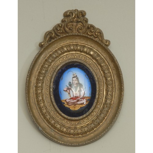 3882 - An Indian enamel plaque, decorated in polychrome with a female deity, the brass frame chased with lo... 