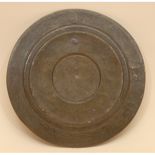 3919 - A 19th century Indian silver overlaid copper circular charger, chased with deities and lotus, 31cm d... 