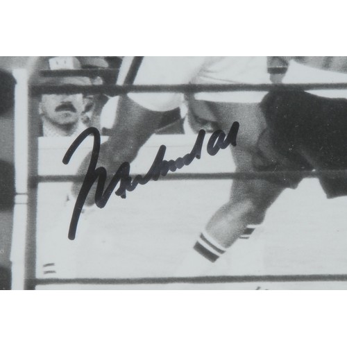 3370 - Sporting Memorabilia - a mid-century signed boxing photograph, showing Muhammad Ali vs Ken Norton II... 