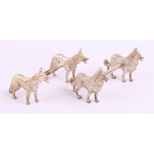 44 - A pair of silver plated novelty knife rests, each cast with a pair of dogs, 9cm wide, 20th century