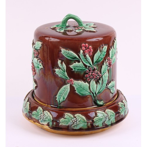 768 - A 19th century majolica cheese dome and stand, moulded in relief with holly, 28cm high, c.1880