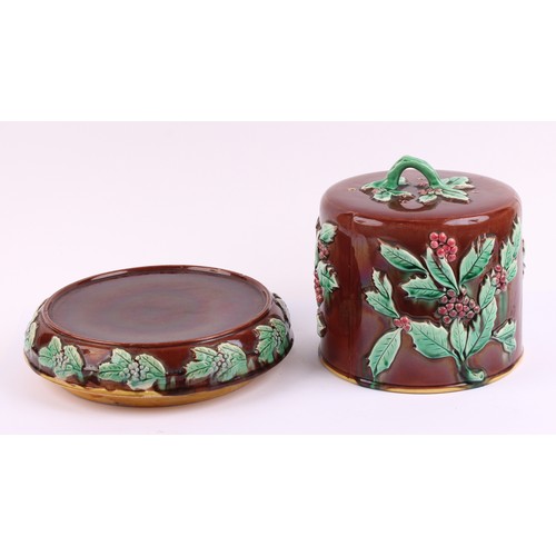 768 - A 19th century majolica cheese dome and stand, moulded in relief with holly, 28cm high, c.1880