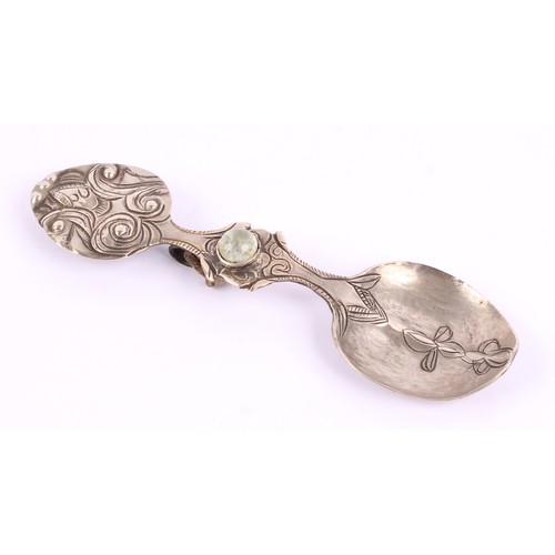 14 - A Tibetan Buddhist silver coloured metal tsog spoon, chased with scrolls and set with a cabochon, 12... 