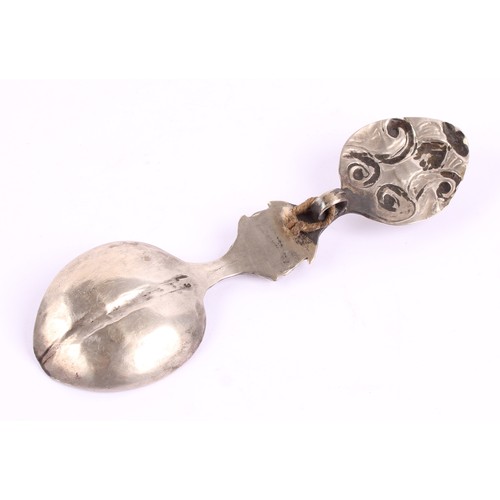 14 - A Tibetan Buddhist silver coloured metal tsog spoon, chased with scrolls and set with a cabochon, 12... 