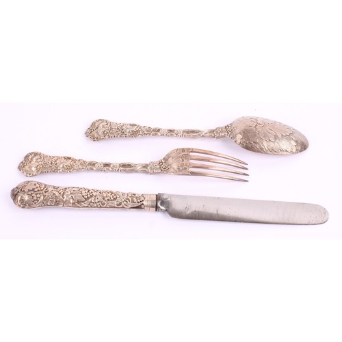 17 - A Victorian silver chased vine pattern Christening set, comprising spoon, knife and fork, the knife ... 