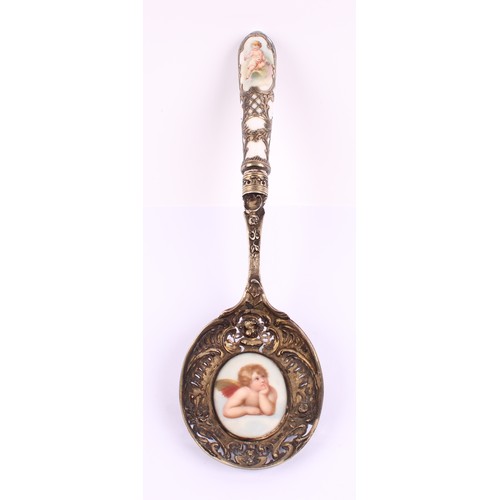 27 - A German silver gilt and porcelain mounted spoon, pierced and cast with flowering urns, busts and sc... 