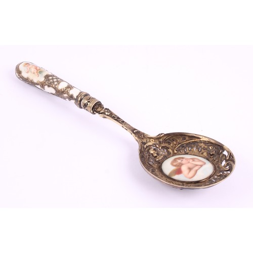27 - A German silver gilt and porcelain mounted spoon, pierced and cast with flowering urns, busts and sc... 