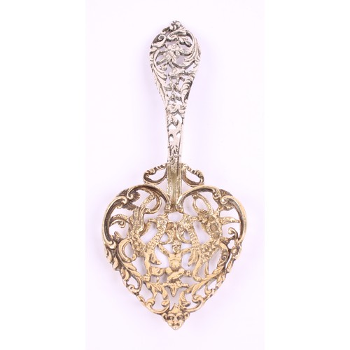 15 - A Victorian silver bon bon spoon, gilt heart shaped bowl, pierced and cast with a putto and scrollin... 