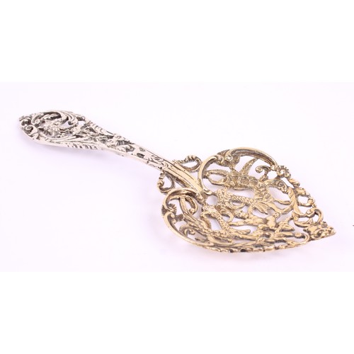 15 - A Victorian silver bon bon spoon, gilt heart shaped bowl, pierced and cast with a putto and scrollin... 