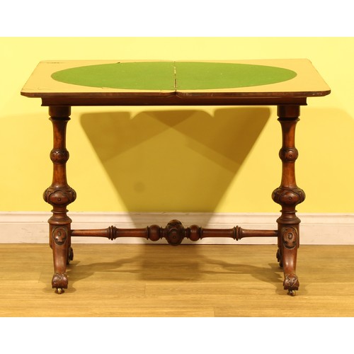 A Victorian walnut card table, hinged top enclosing a baize lined ...
