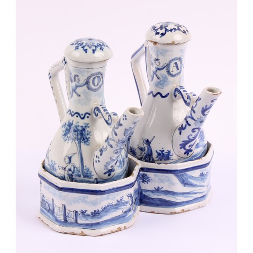 1009 - A Continental Delft oil and vinegar cruet set, comprising two bottles and a stand, the bottles 17.5c... 